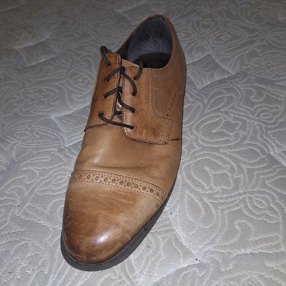 A pair of Cole Haan Oxfords in a men's size 12M. Pre-loved in good condition.